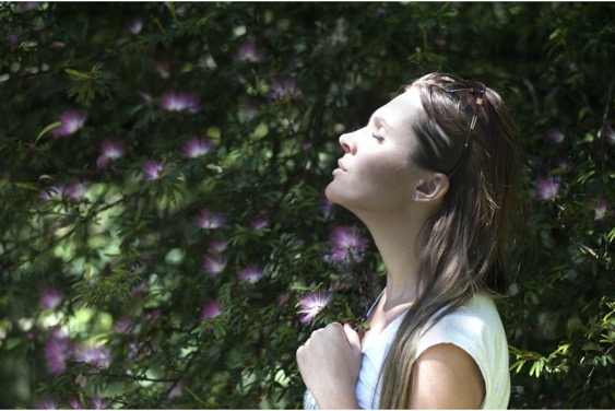 woman smelling scent to relieve stress